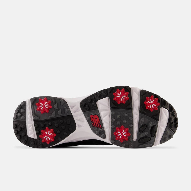 New Balance Golf Brighton Golf shoes outsole in black and white with red cleats and grip-enhancing tread design.