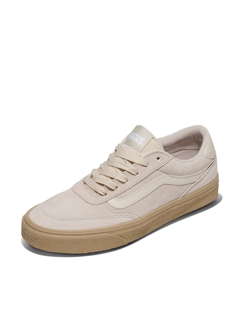 Vans Brooklyn sneakers in beige suede with tonal stitching, white side stripe, and gum outsole, angled front view.