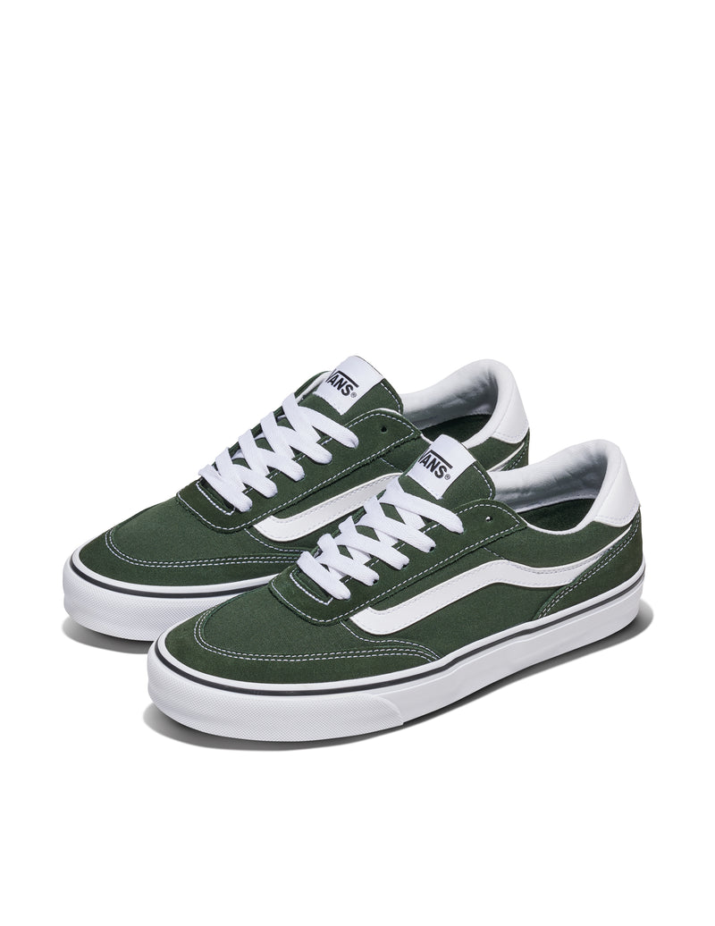 Vans Brooklyn sneakers in green canvas with white laces, leather stripe detailing, and rubber outsole, angled side view.