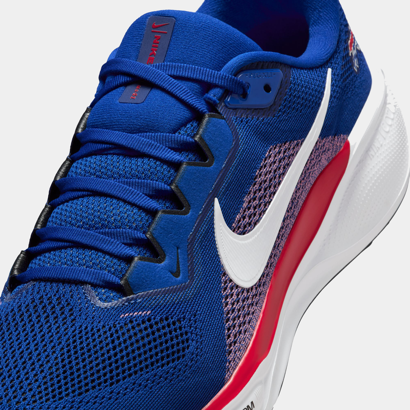 Nike Buffalo Bills Pegasus 41 running shoe in blue with white Swoosh logo, red midsole accents, and breathable mesh upper, angled close-up view.