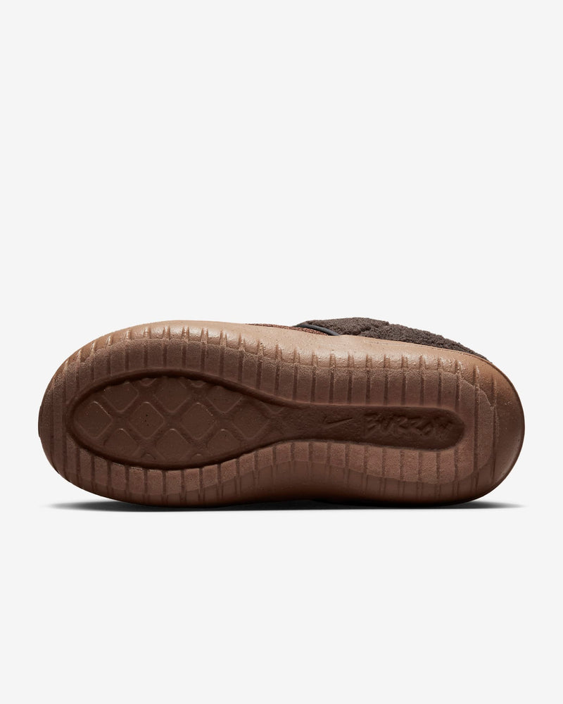 Nike Burrow SE slippers outsole view featuring textured brown rubber with diamond-pattern grip and embossed branding.