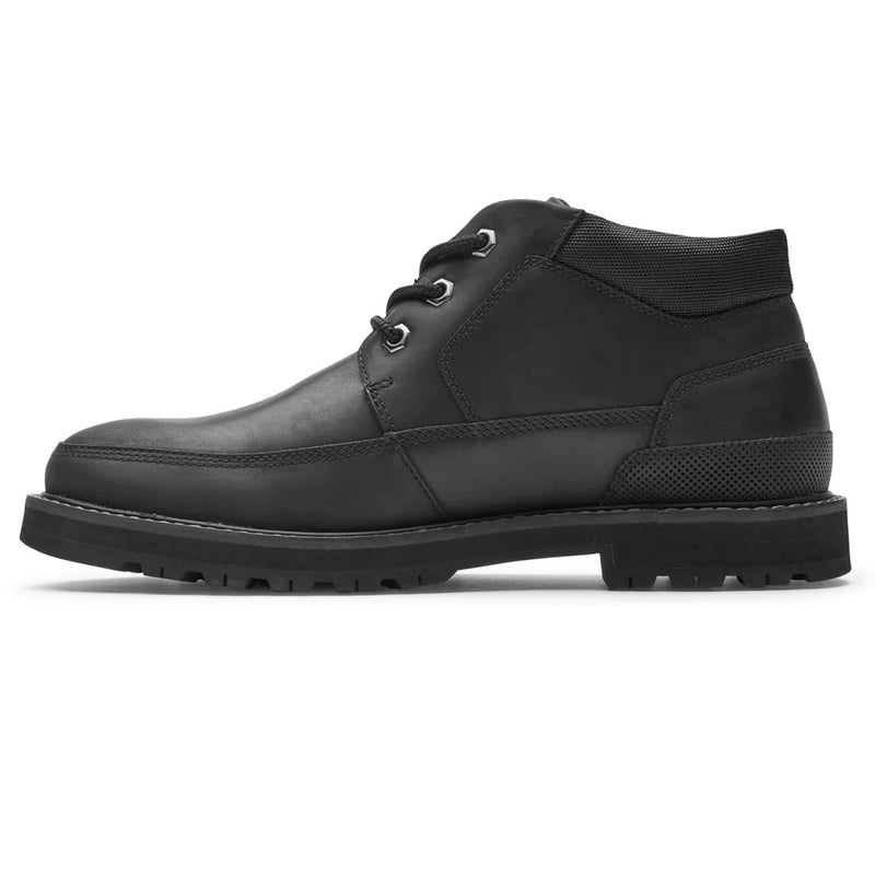 Dunham Byrne Waterproof Chukka Boot in black leather with padded collar, durable lug outsole, and lace-up design, side view.