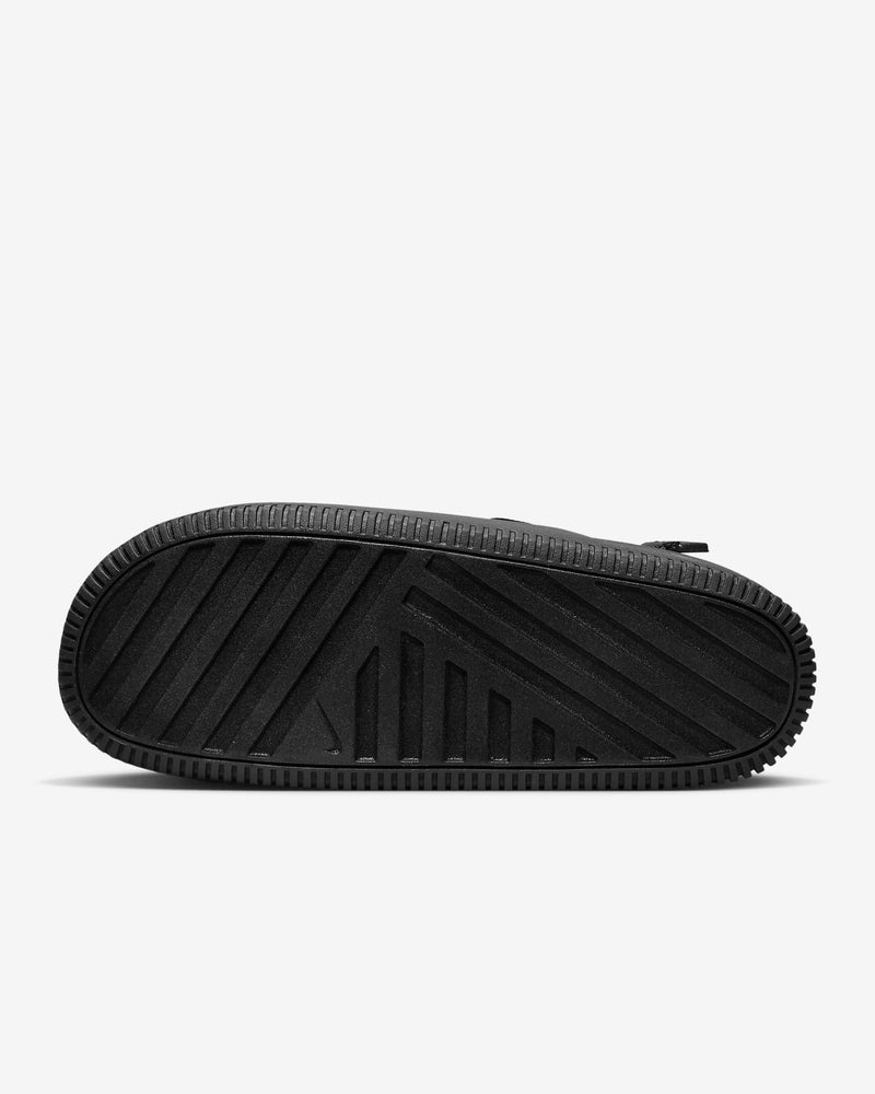 Nike Calm Mule outsole in textured black rubber with geometric tread pattern, sole/bottom view.