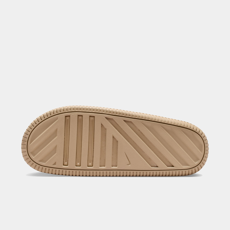 "Nike Calm Slide 2.0 outsole in beige with a textured tread pattern and Nike logo, sole/bottom view"