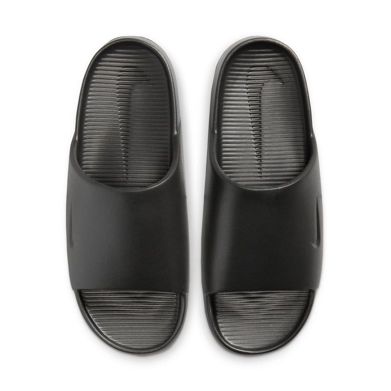 Nike Calm Slide sandals in black with sleek minimalist design and textured footbed, top view.