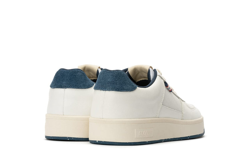 SeaVees Cardinal Sneaker in white with blue suede heel accent and textured cream sole, back view.