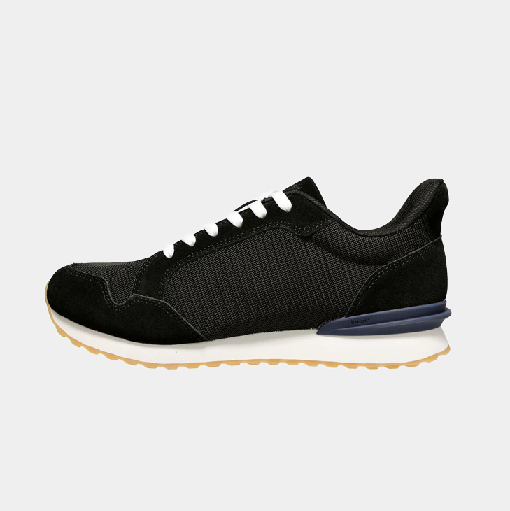 Propét Carmine Step In Sneakers, black with mesh upper, suede overlays, white laces, and gum rubber outsole, side view.