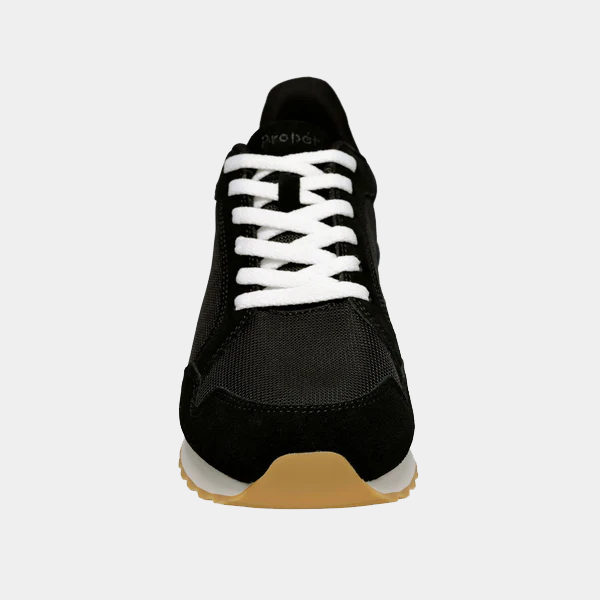 Propet Carmine Step In Sneakers front view, black upper with white laces, mesh fabric, and suede overlays, gum rubber outsole.