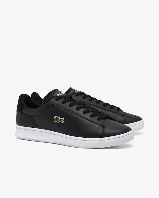 Lacoste Carnaby Set Leather Sneakers in black with sleek leather upper, lace-up design, and signature crocodile logo, side view.