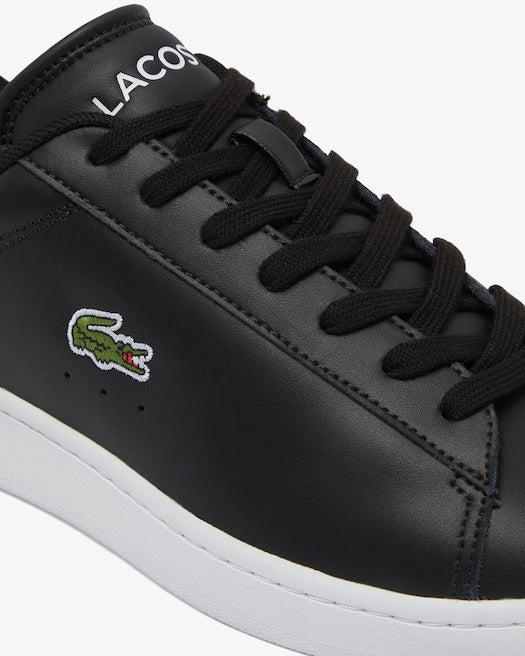 Lacoste Carnaby Set Leather Sneakers in black with embroidered crocodile logo, smooth leather upper, and white outsole, side view.