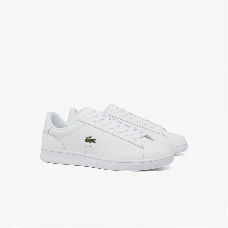 Lacoste Carnaby Set Leather Sneakers in white with sleek leather upper, embroidered crocodile logo, and lace-up design, side view.