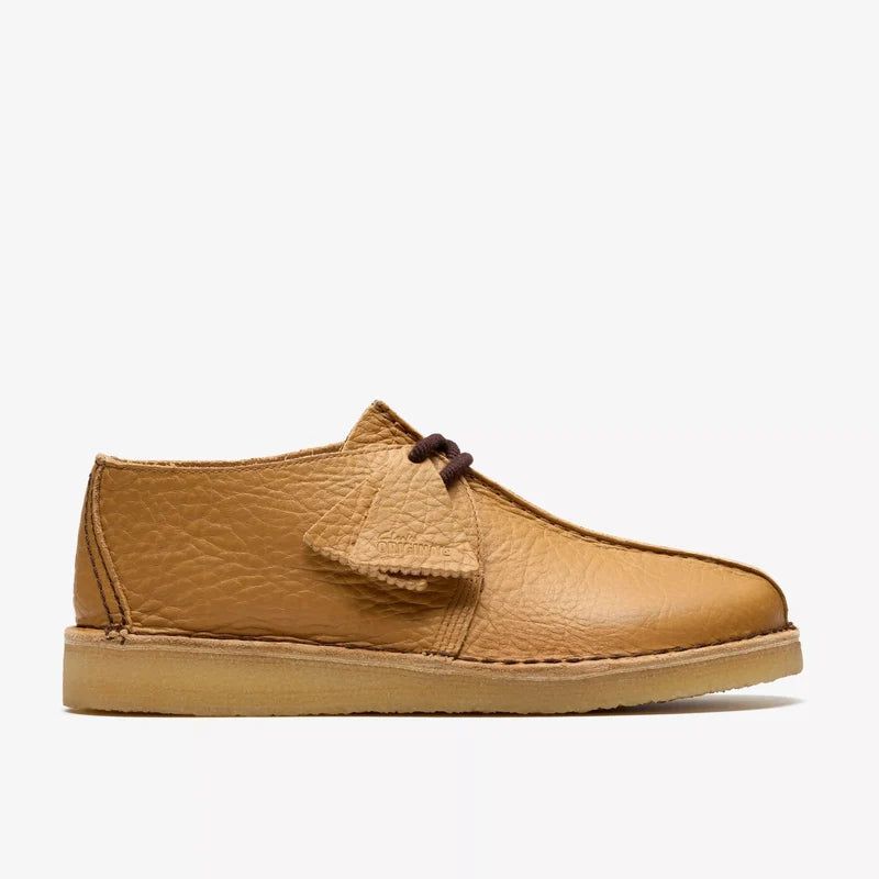 Tan leather shoe with a brown laces on a white background