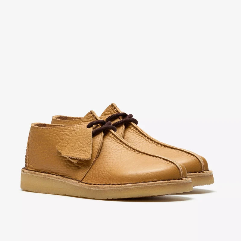Tan leather desert boots on a white background