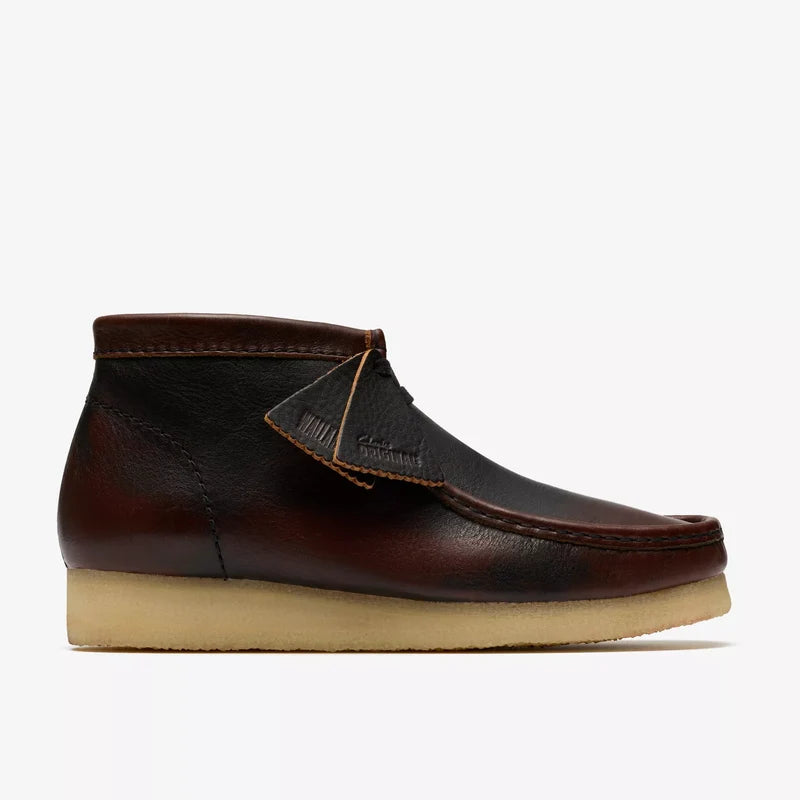 Brown leather shoe with beige sole on a white background
