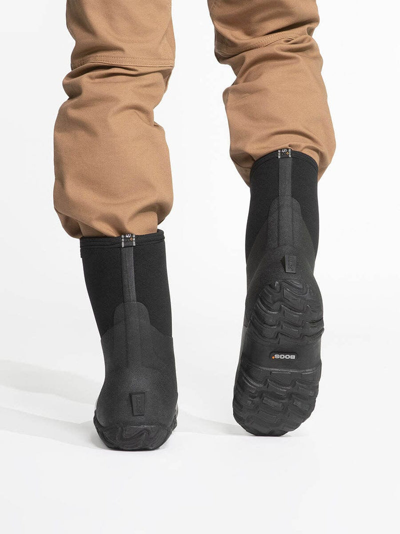 Bogs Classic Mid Boot black waterproof boots with textured rubber outsoles, back view showing tread pattern.