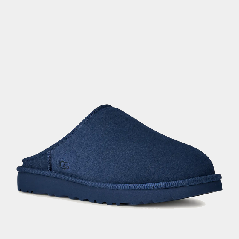 UGG Classic Slip-On shoes in navy blue with a suede upper and lightweight sole, angled side view.
