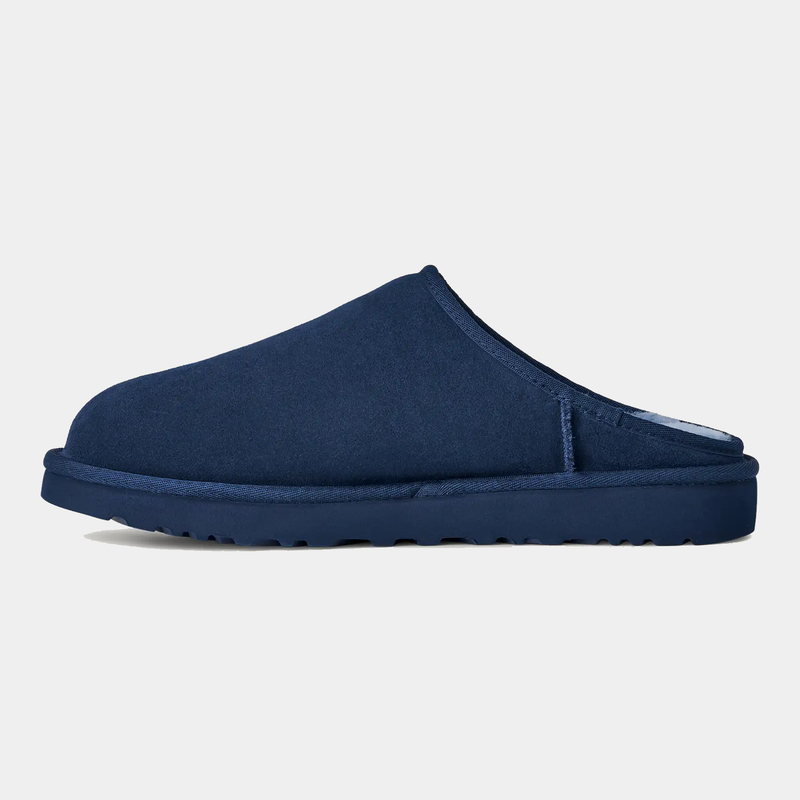 UGG Classic Slip-On slippers in deep navy with soft suede upper and durable sole, side view.