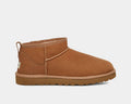 UGG Classic Ultra Mini Boot in chestnut brown suede with shearling lining and durable Treadlite sole, side view.