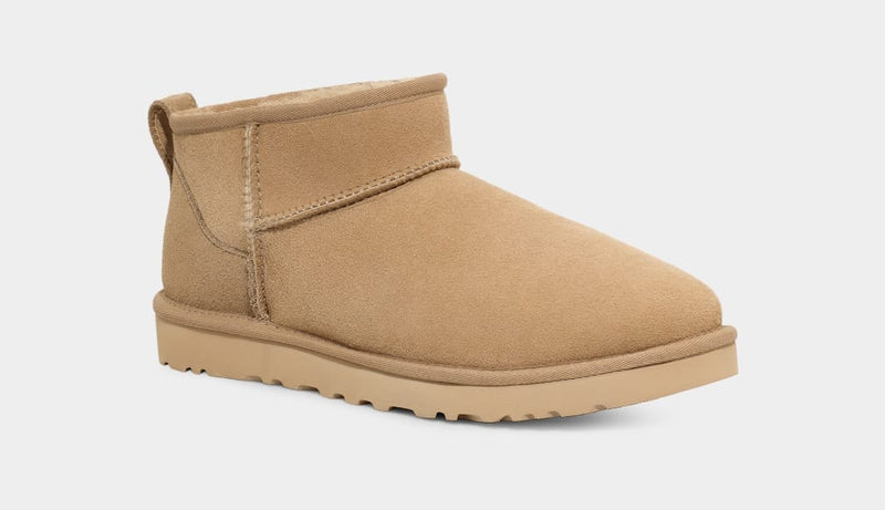 UGG Classic Ultra Mini Boot in chestnut suede with plush lining and lightweight sole, side view.