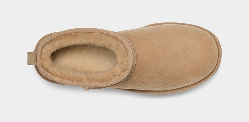 UGG Classic Ultra Mini Boot in chestnut suede with plush shearling lining, top view showing slip-on design.