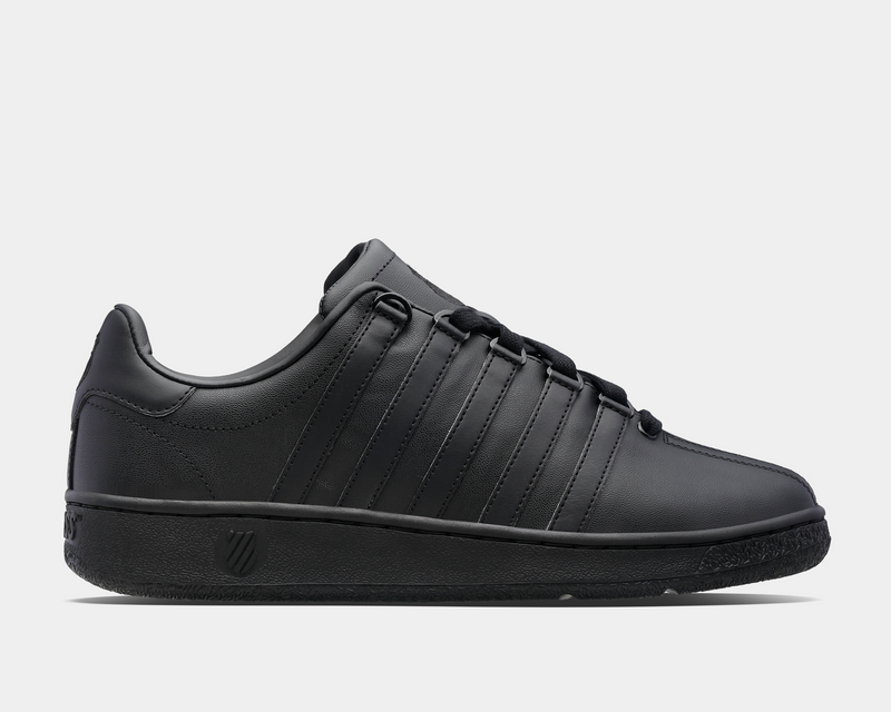 K-Swiss Classic VN sneakers in black leather with signature five-stripe design and durable outsole, side view.