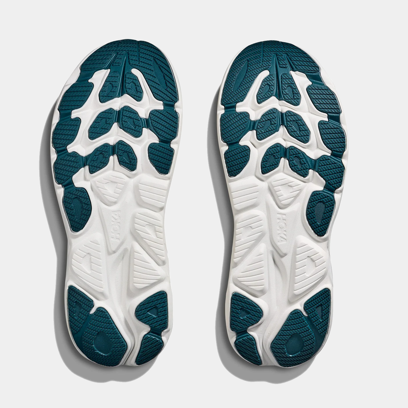 HOKA Clifton 10 running shoe soles with teal rubber pads and white grooves designed for traction and flexibility, bottom view.