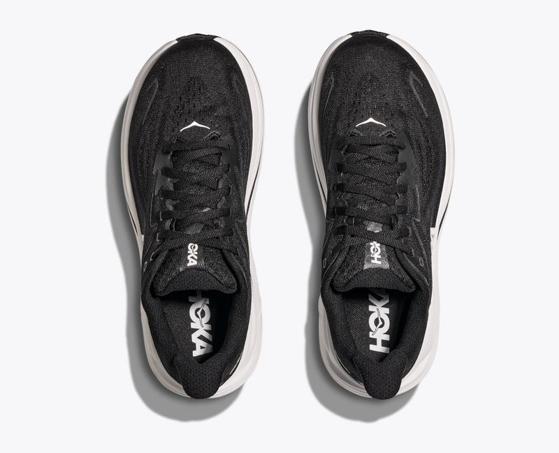 HOKA Clifton 10 running shoes in black with breathable mesh upper and cushioned midsole, top view.