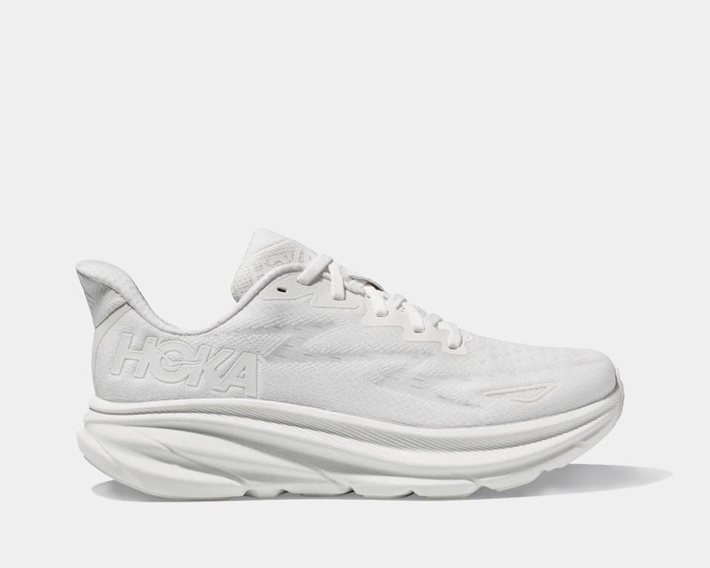 HOKA Clifton 9 running shoes in all-white with breathable mesh upper and cushioned midsole, side view.