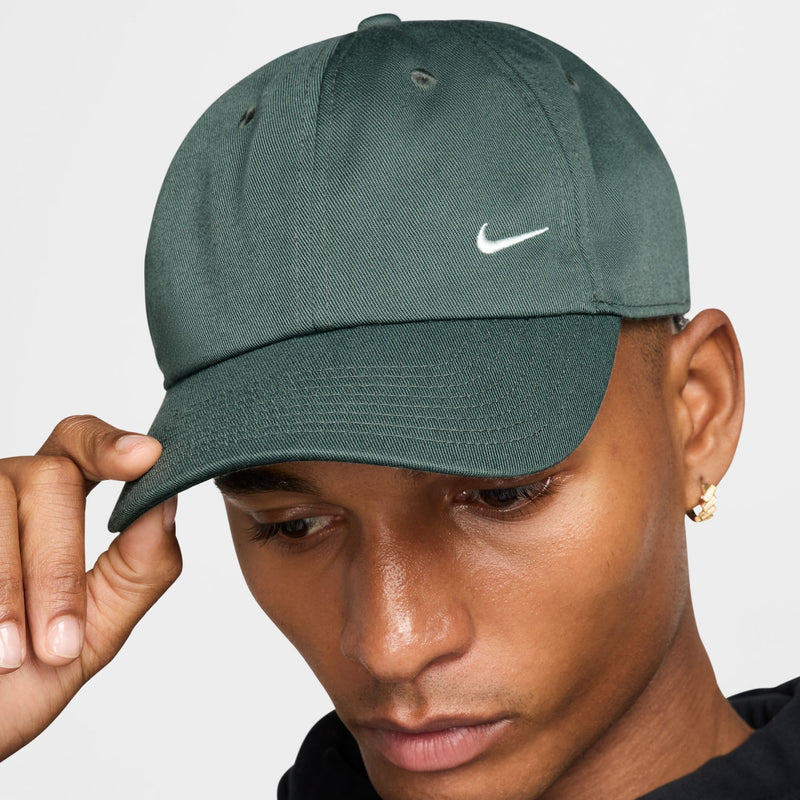 Nike Club Hat in dark green featuring embroidered white Nike logo, front view.