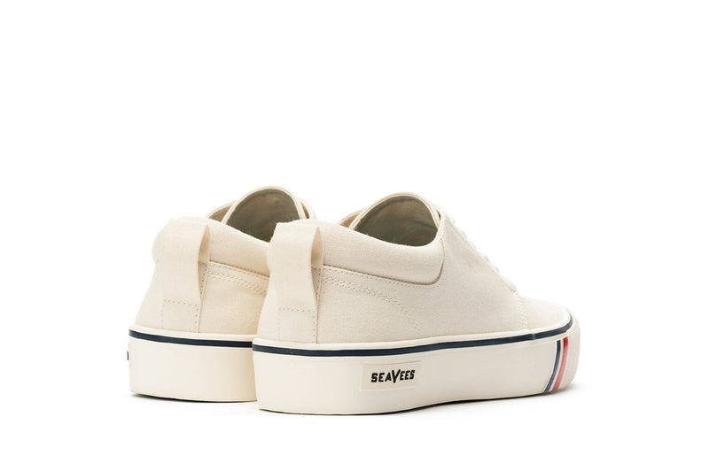 SeaVees Coastal Cruiser sneakers in off-white canvas with pull tabs and striped detail on the sole, back view.