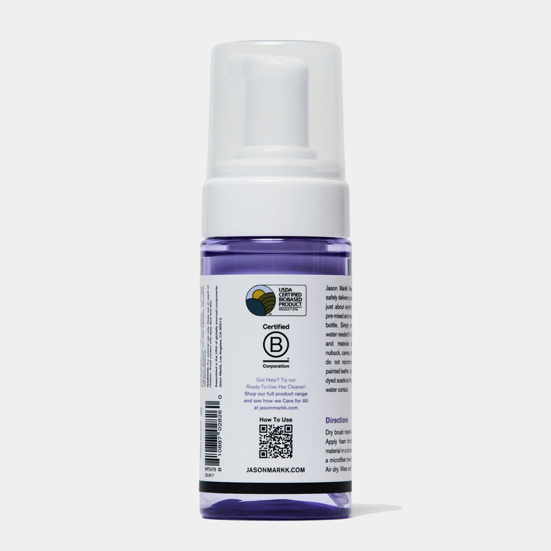 Jason Markk Complete Clean Kit cleaning bottle with purple liquid and white pump top, back view showing label and instructions.