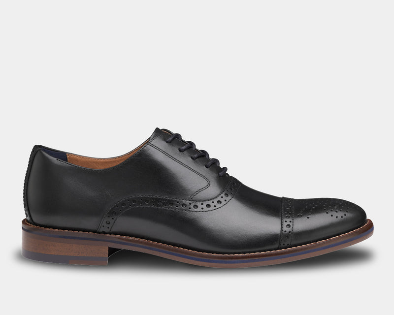 Johnston & Murphy Conard Cap Toe dress shoes in black leather with brogue detailing and wooden heel, side view
