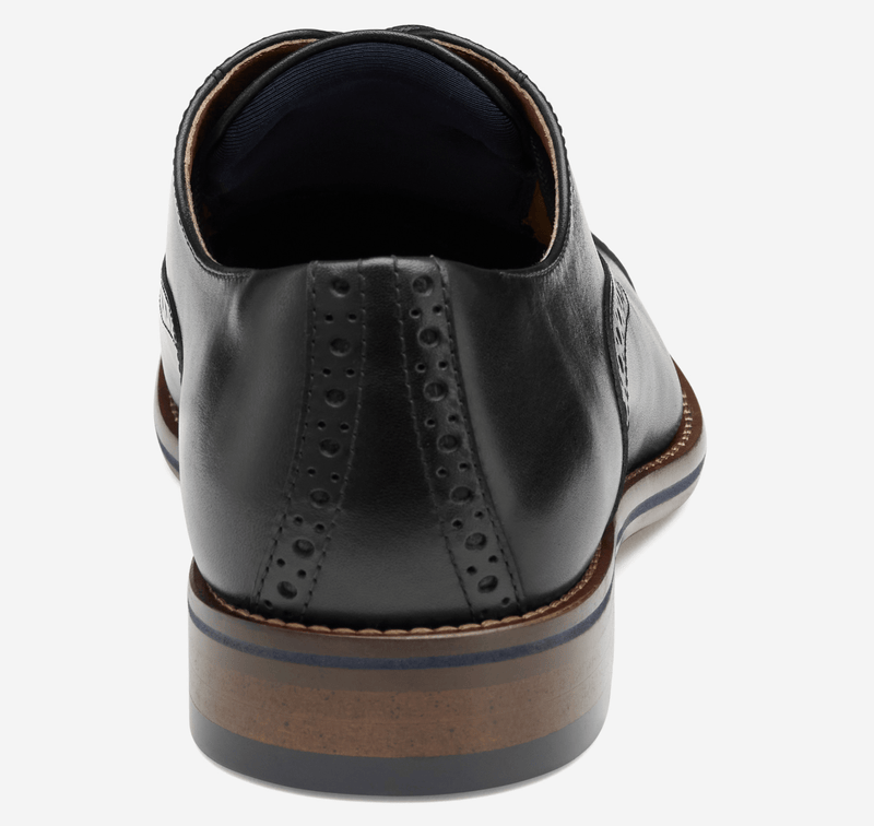 Johnston & Murphy Conard Cap Toe dress shoes in black leather with brogue detailing, back view showing stacked heel and sole contrast.
