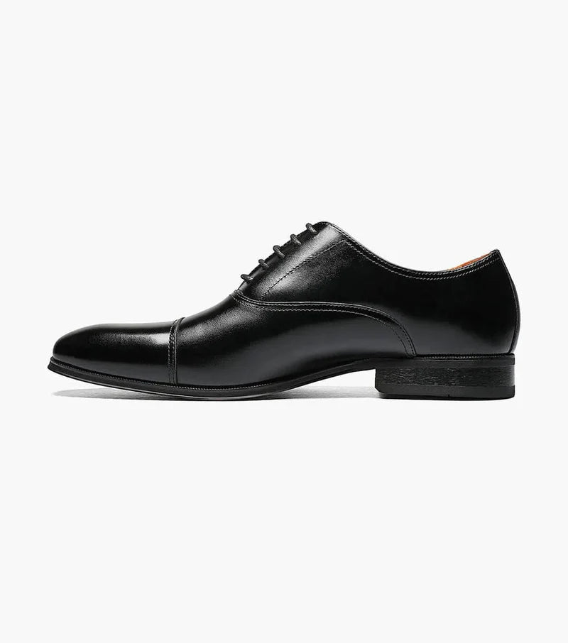Florsheim Corbetta dress shoes in black leather with cap toe design and stacked heel, side view.