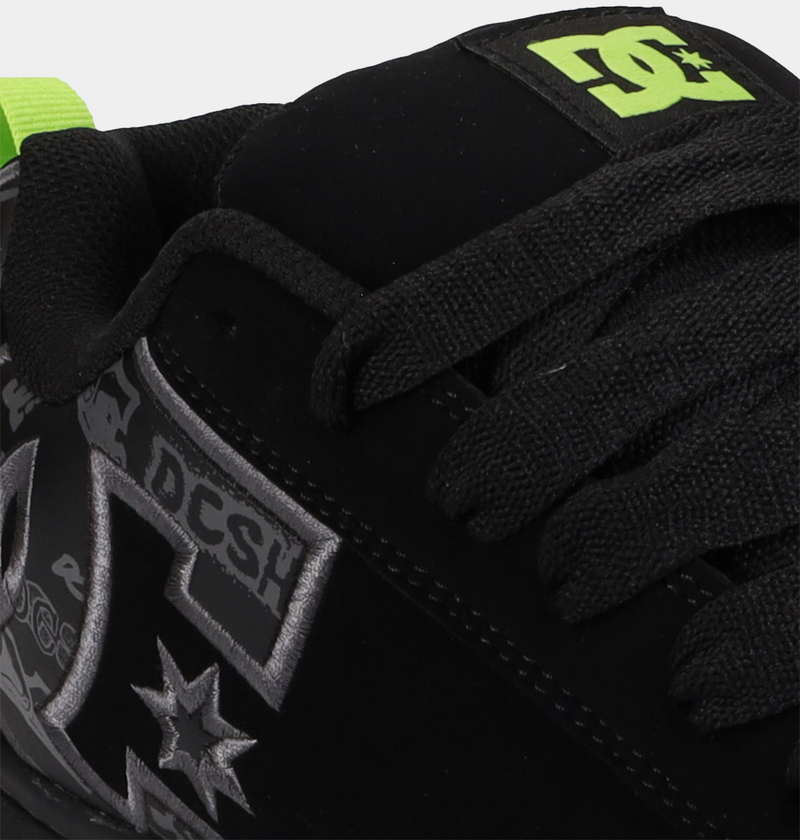 DC Footwear Court Graffik sneakers in black with gray graphic detailing, padded collar, and lime green logo, close-up view.