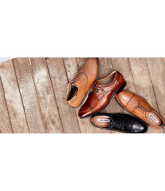 Steve Madden Covet dress shoes in brown, cognac, and black leather with lace-up and buckle styles on rustic wooden surface.