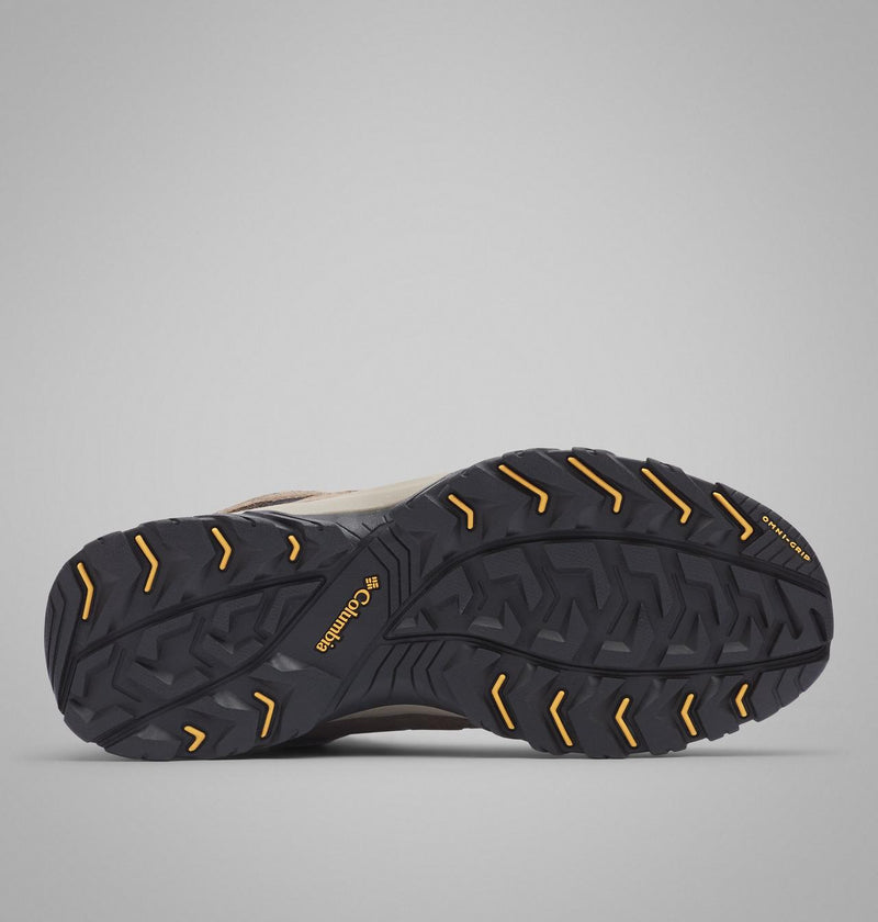 Columbia Crestwood Mid Waterproof hiking boots outsole with Omni-Grip traction and rugged tread pattern in black and orange rubber.
