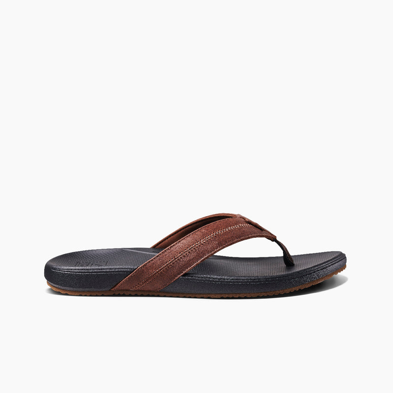 Reef Cushion Phantom 2.0 LE sandals in brown leather with a black cushioned footbed and textured outsole, side view.