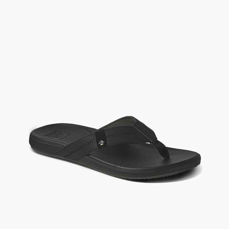 Reef Cushion Phantom 2.0 sandals in black with soft padded straps, cushioned footbed, and textured outsole, angled side view.