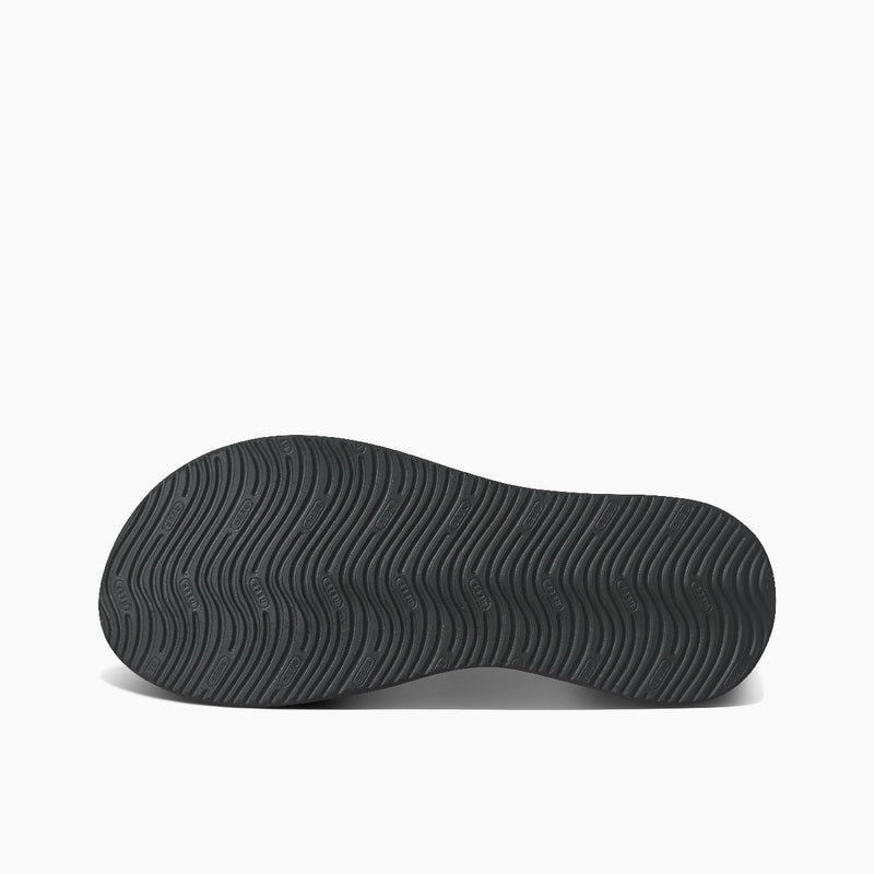 Reef Cushion Phantom 2.0 sandals outsole with textured wave-pattern tread in black rubber, bottom view.