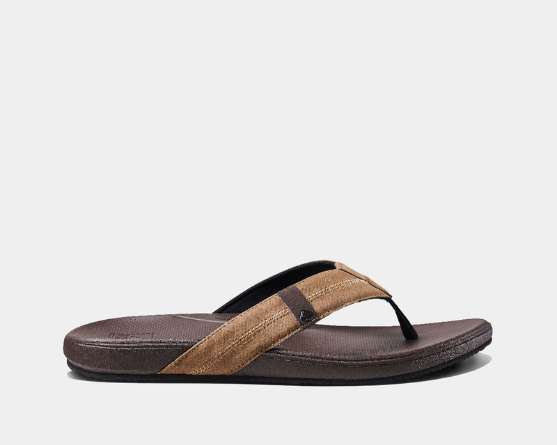 Reef Cushion Phantom 2.0 flip-flops in brown with a cushioned footbed, textured straps, and durable outsole, side view.