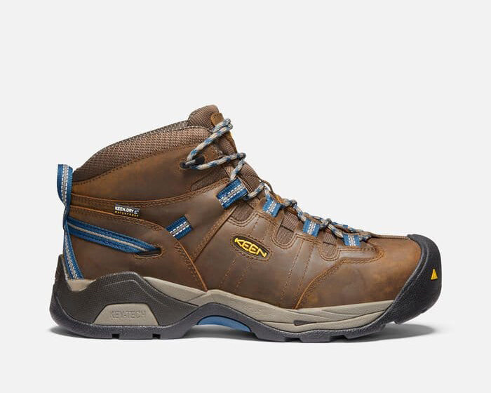 Keen Detroit XT Steel Toe Mid Waterproof Boots in brown leather with blue accents, side view showing durable design and protective toe cap.