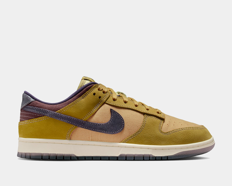 Nike Dunk Low Retro SE sneakers in tan, mustard yellow, and purple with a textured upper and contrasting dark swoosh, side view.