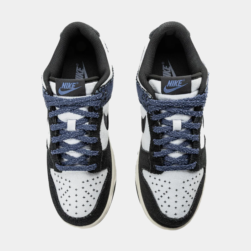Nike Dunk Low Retro sneakers with white perforated toe box, black overlays, and blue textured laces, top view.