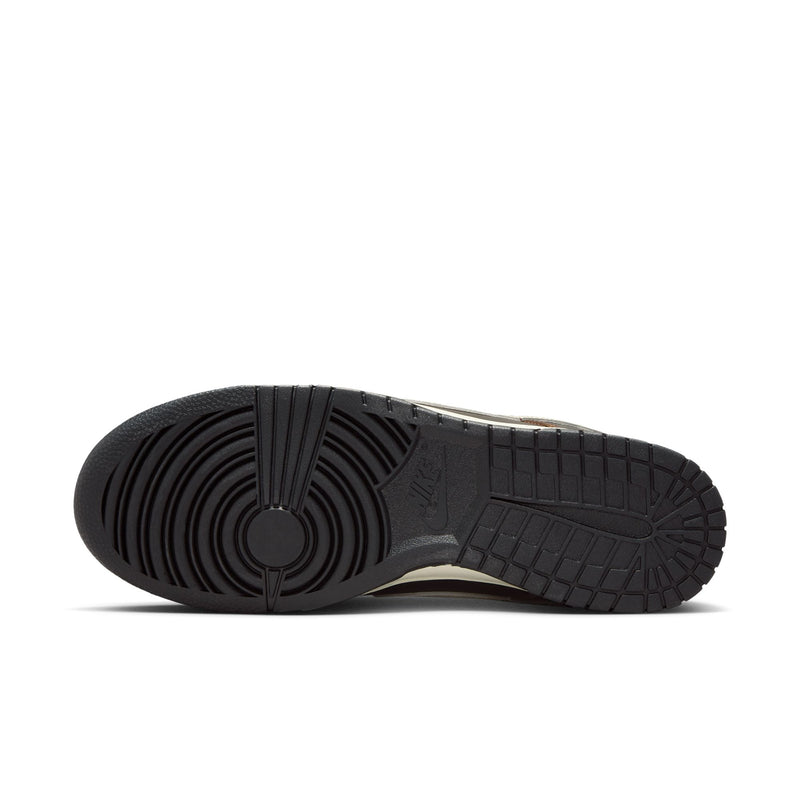 Nike Dunk Low outsole in black rubber with circular tread pattern and embossed branding, sole/bottom view.