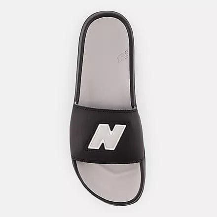 New Balance DynaSoft 200v2 VRSTY slides in black with a white New Balance logo and cushioned footbed, top view.
