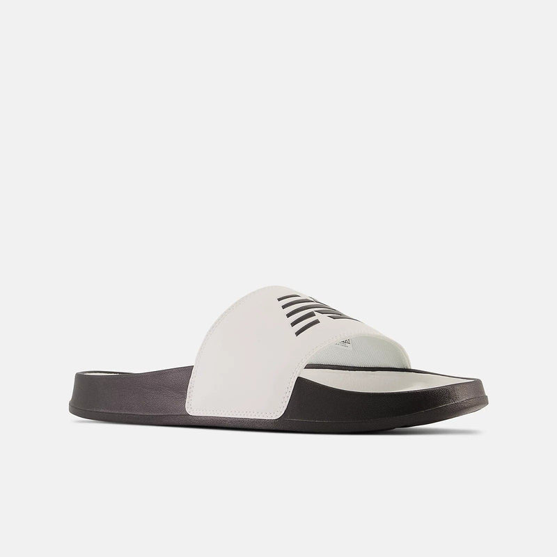 New Balance DynaSoft 200v2 slides in white and black with cushioned sole and wide logo-printed strap, angled side view.