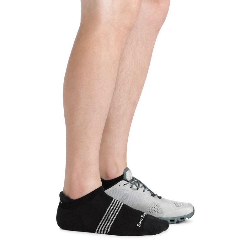Darn Tough Element No Show Tab Lightweight Running Sock in black with white stripe accents and reinforced heel, lifestyle view worn with running shoes.