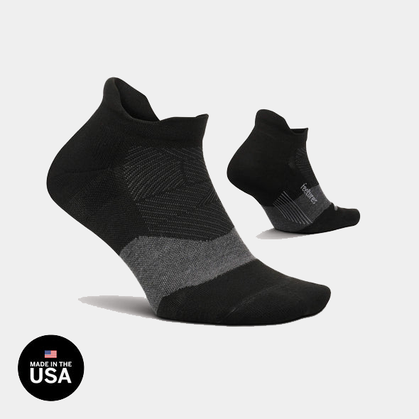 Feetures Elite Golf Max Cushion No Show Tab socks, black with gray accents, side view showing reinforced heel and toe.