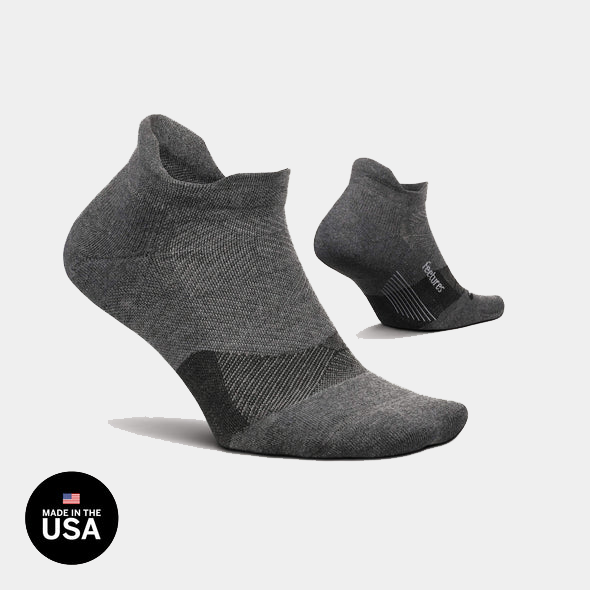 Feetures Elite Golf Max Cushion No Show Tab socks in dark gray with high-density cushioning and no-show design, side view.